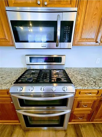 a stove top oven sitting inside of a kitchen