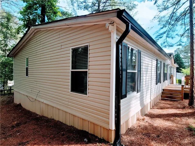 a backyard of a house with wooden fence