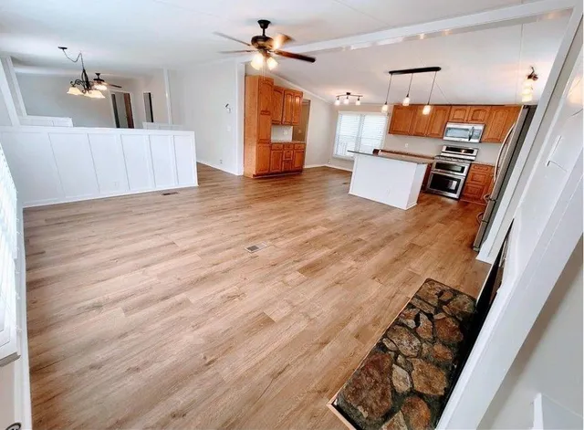 a view of a kitchen with furniture and wooden floor