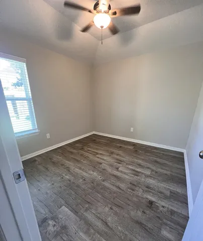 a utility room with washing machine and a view of bedroom