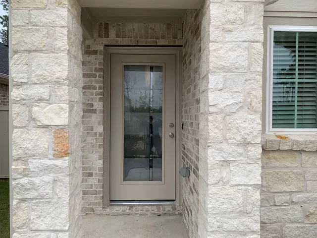 a brick house with a door and a window