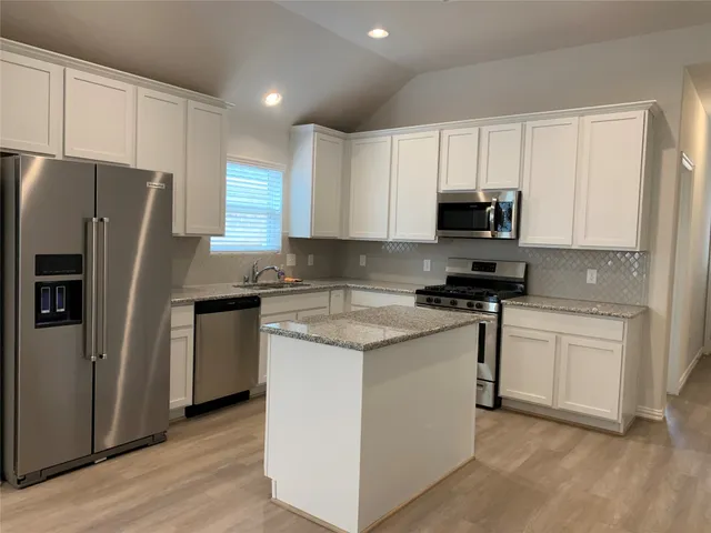 a kitchen with a sink and a stove top oven