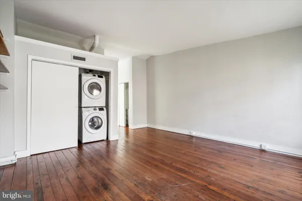 a view of washer and dryer with wooden floor