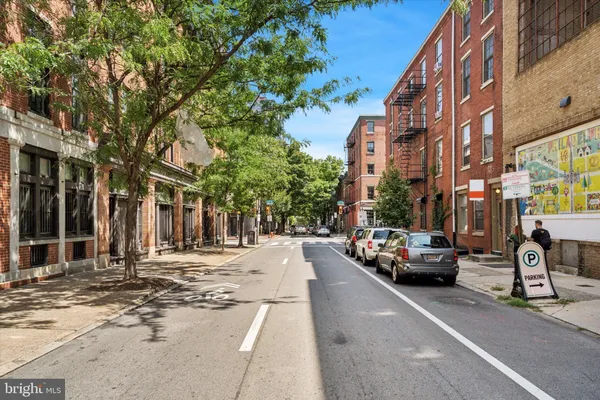 a city street lined with buildings and cars