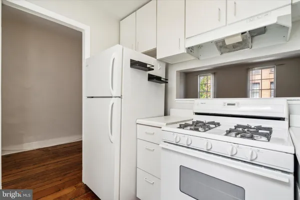 a white refrigerator freezer sitting inside of a kitchen