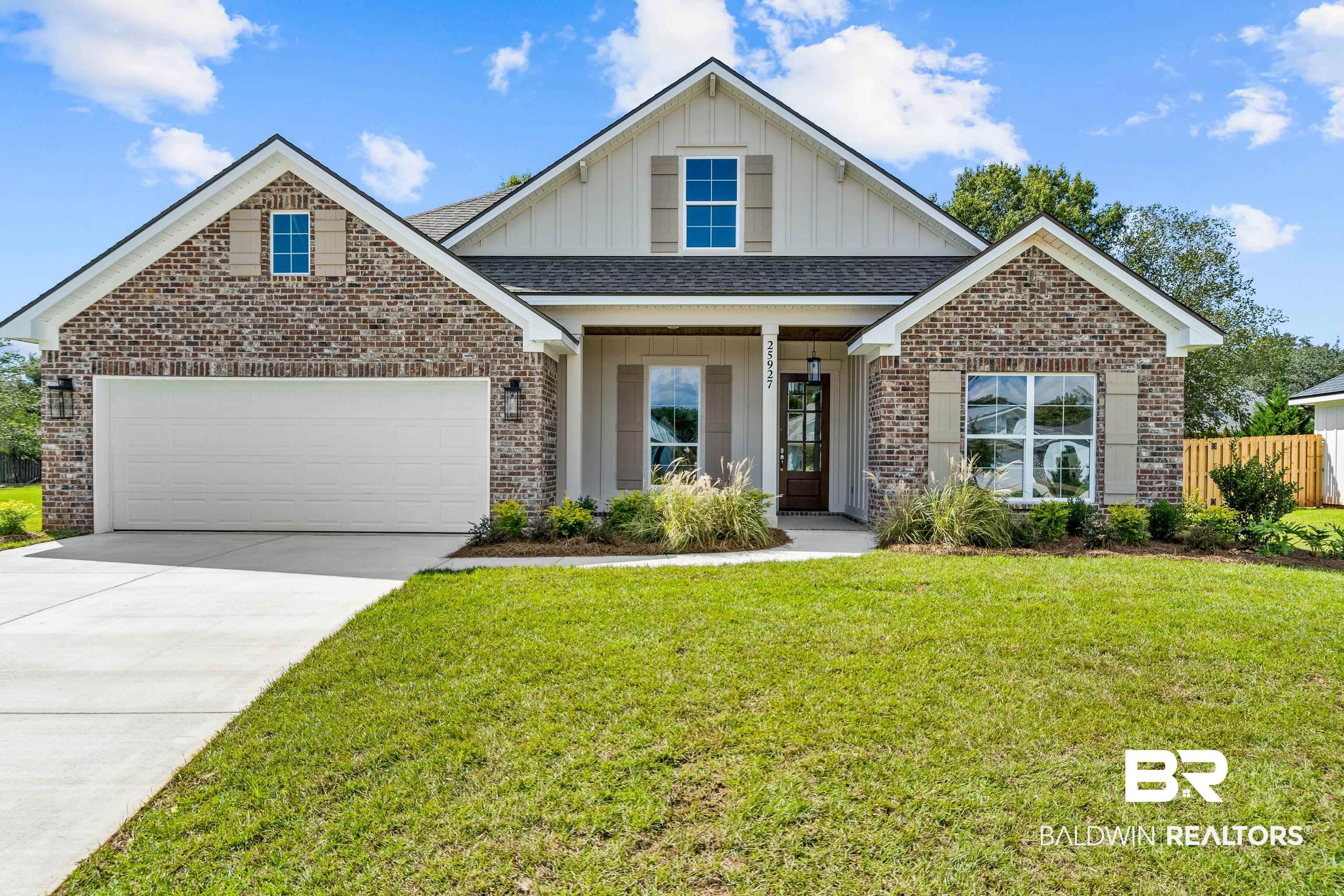 25927 Capra Court Daphne, AL 36526 - Photo 1 of 37 View of front of home featuring a garage, a front lawn, and covered porch