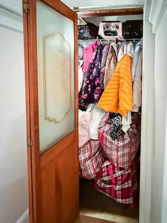 an empty room with wooden floor and cabinet
