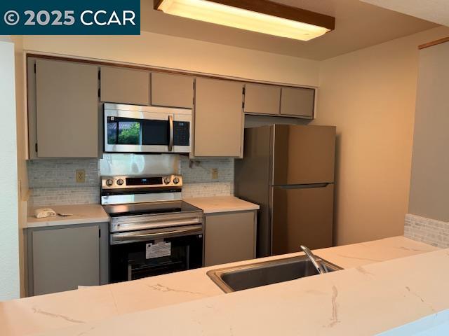 10 Tarn Court Hercules, CA 94547 - Photo 11 of 21 a kitchen with a refrigerator and a stove