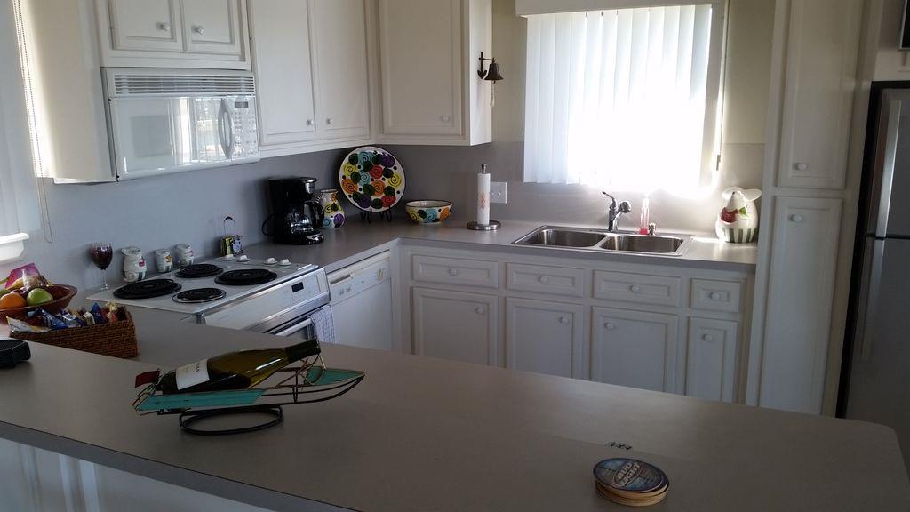 844 Beach Walk Boulevard Conroe, TX 77304 - Photo 16 of 20 a kitchen with a sink a stove and cabinets