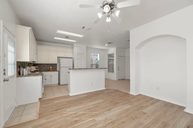 a view of a kitchen with wooden floor and a kitchen