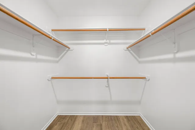 a view of walk in closet with empty racks