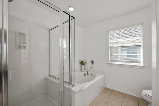 a bathroom with a bathtub and a window