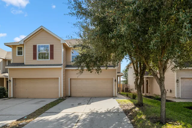 a front view of house with yard and trees