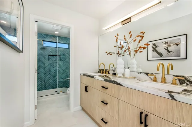 a bathroom with a granite countertop sink mirror and vanity