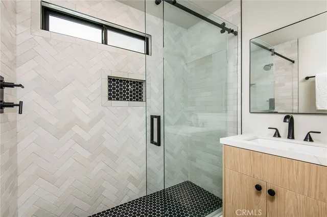 a bathroom with a shower and a sink