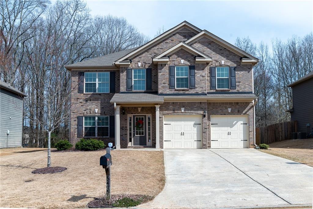 5475 Ripken Road Cumming, GA 30028 - Photo 1 of 1 a front view of a house with a yard and garage