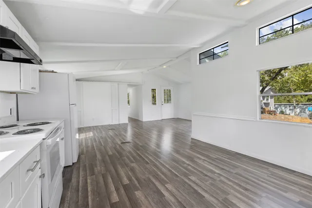 a view of a kitchen with wooden floor and a sink