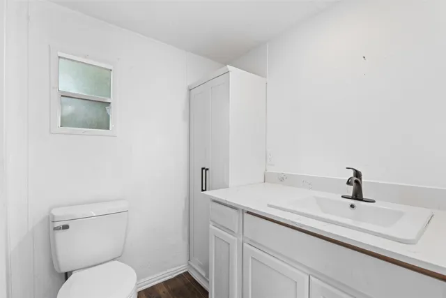 a bathroom with a toilet a sink and mirror