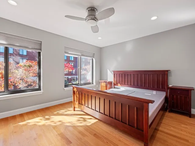 a view of a bedroom with furniture window and wooden floor