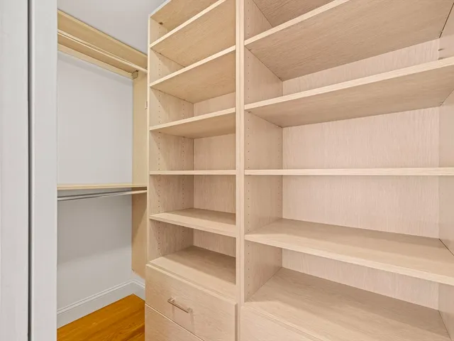 a bathroom with a shower sink vanity mirror and toilet