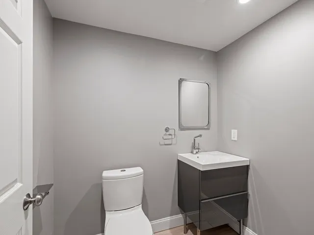 a view of a house with a wooden fence