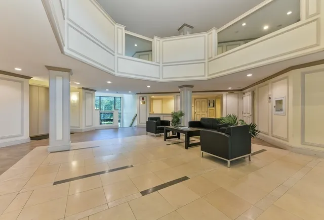 a view of a swimming pool with lawn chairs under an umbrella