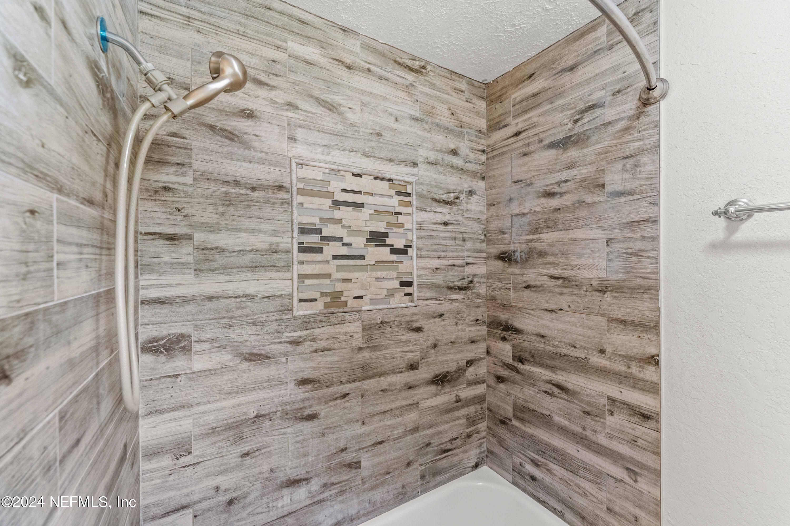 8545 Addison Road Jacksonville, FL 32208 - Photo 12 of 26 a bathroom with a shower