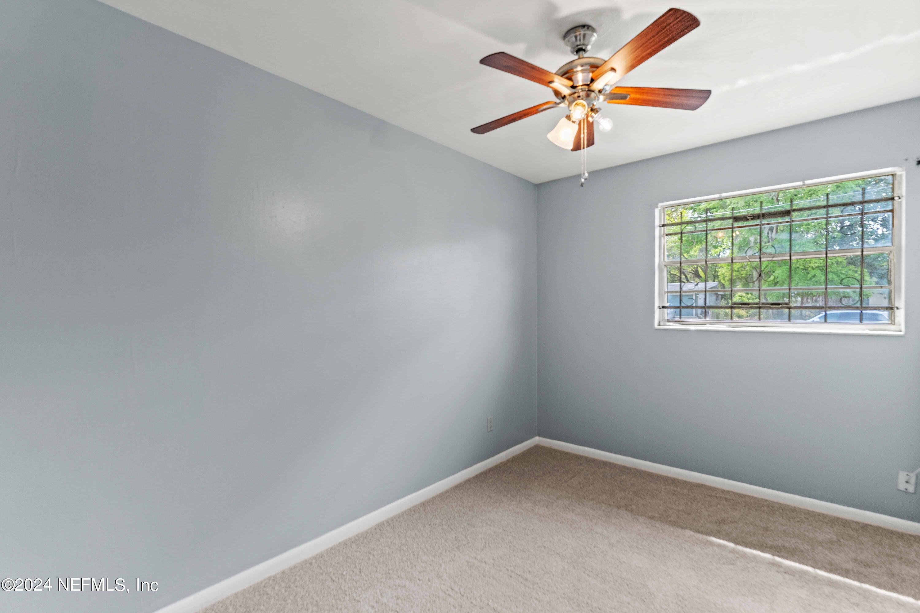 8545 Addison Road Jacksonville, FL 32208 - Photo 18 of 26 an empty room with a window and a fan