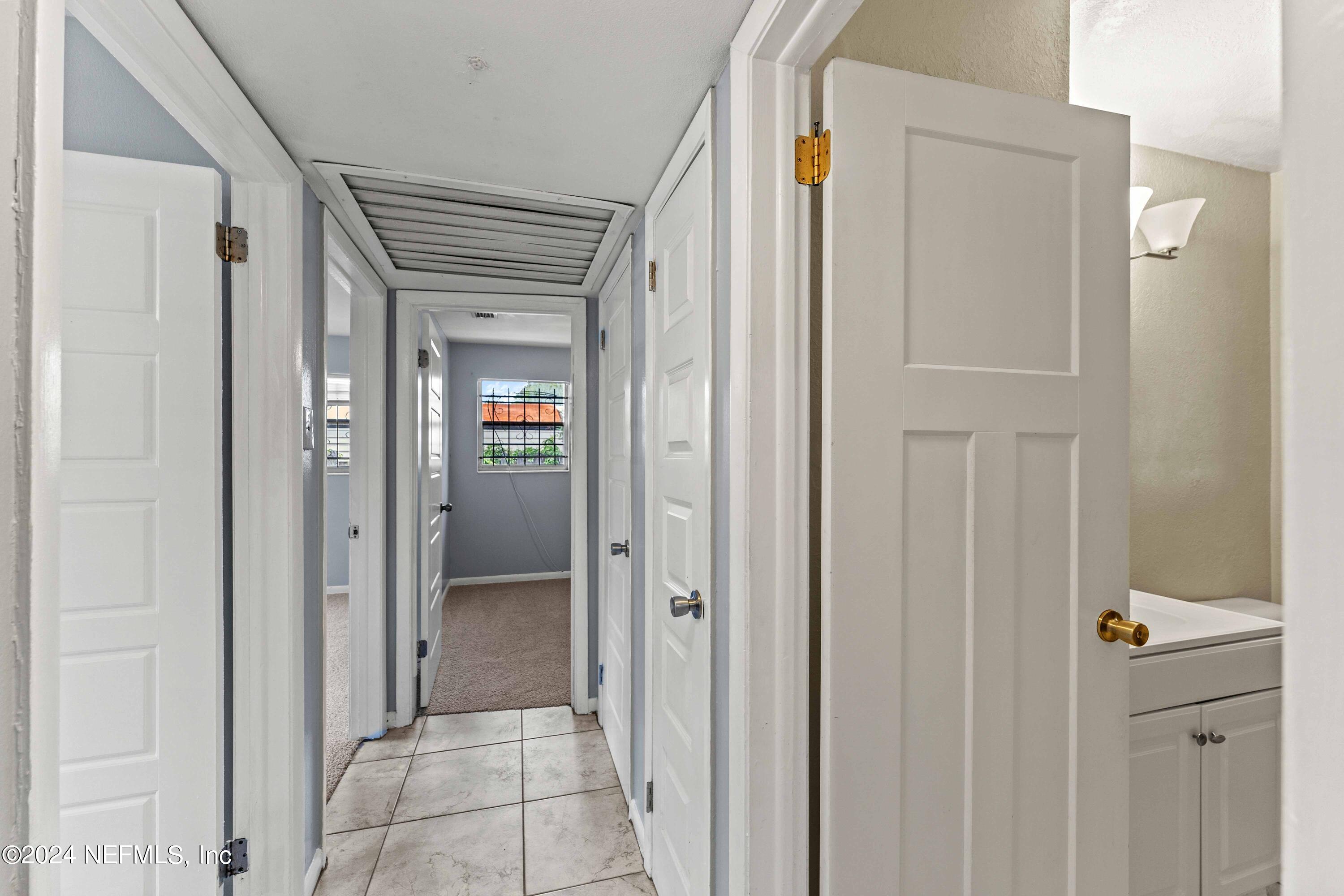 8545 Addison Road Jacksonville, FL 32208 - Photo 19 of 26 a view of a hallway with wooden floor and closet