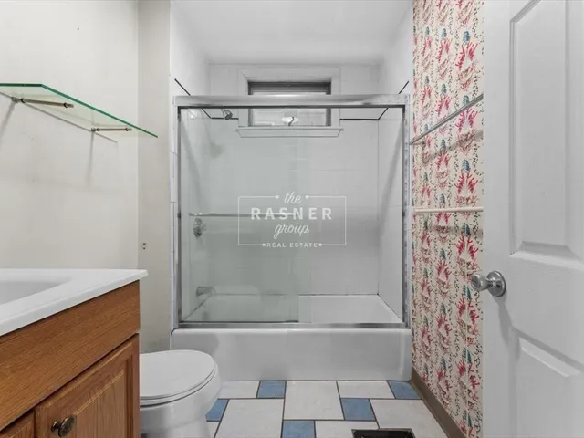 a bathroom with a shower curtain and a toilet