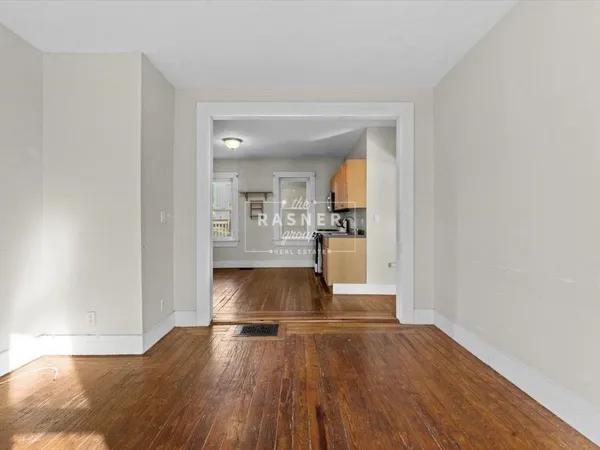 a view of kitchen and hall with wooden floor