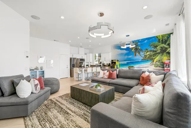 a view of a dining room with furniture and chandelier