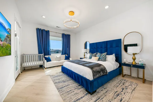 a bedroom with a bed and a painting on the wall