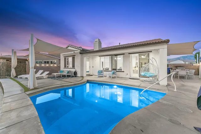 a view of a patio with table and chairs and potted plants