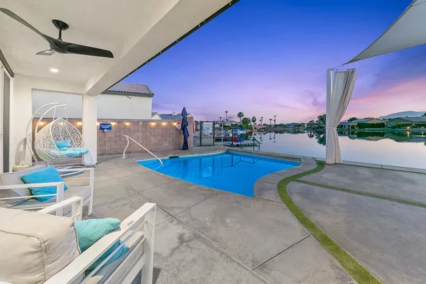 a living room with furniture and a floor to ceiling window