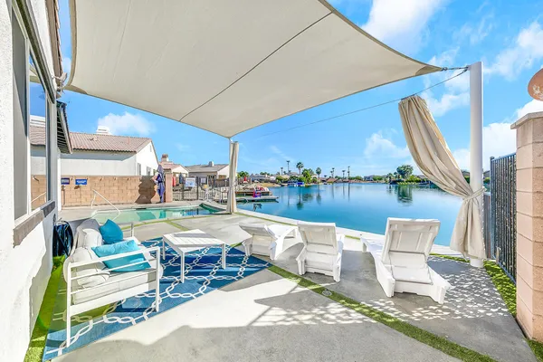 a roof deck with table and chairs and potted plants