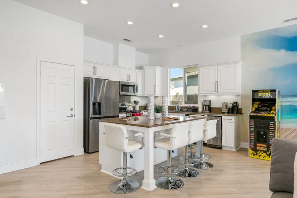 a kitchen with refrigerator and cabinets