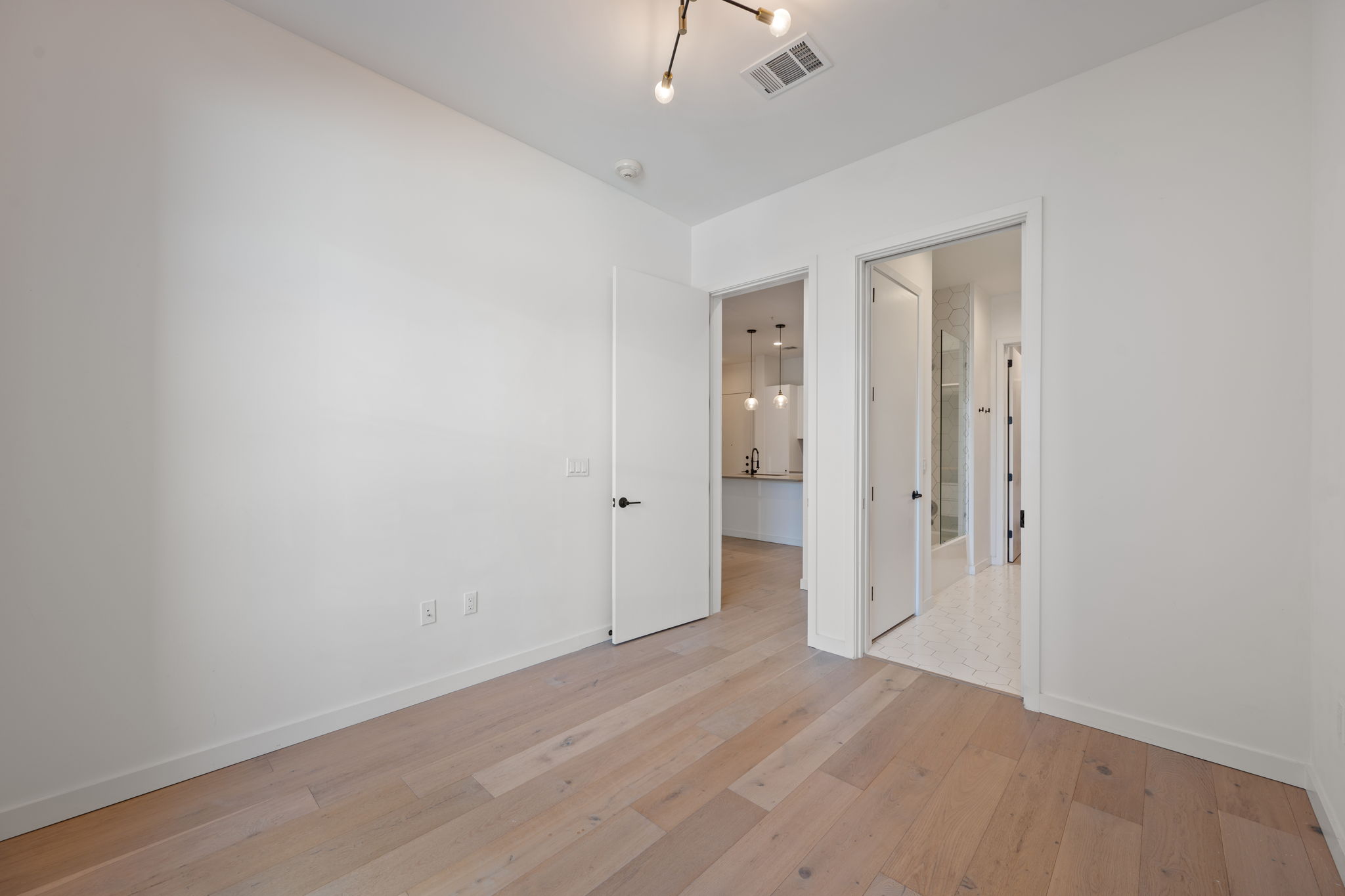800 Embassy Drive, Unit 322 Austin, TX 78702 - Photo 14 of 31 wooden floor in an empty room