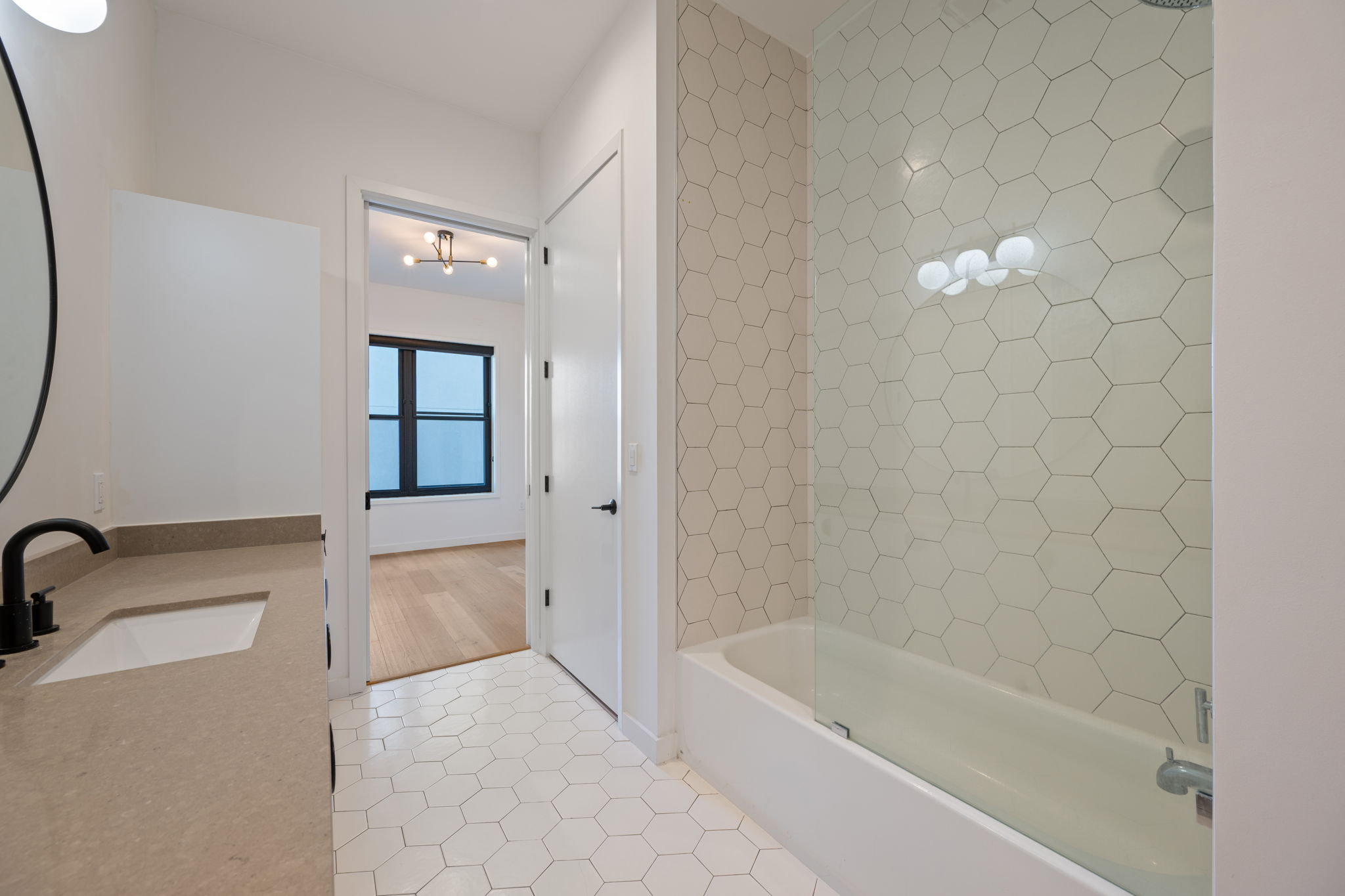 800 Embassy Drive, Unit 322 Austin, TX 78702 - Photo 17 of 31 a bathroom with a bathtub and a shower