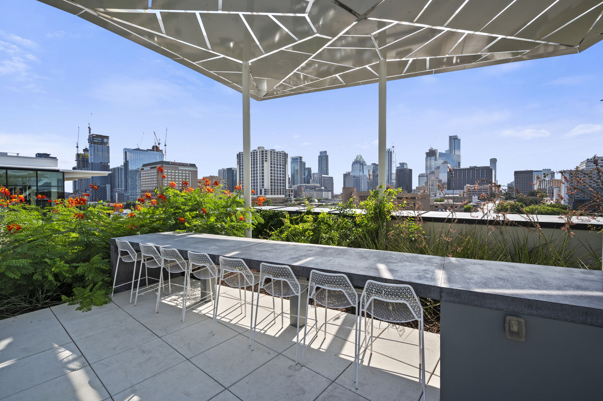 800 Embassy Drive, Unit 322 Austin, TX 78702 - Photo 24 of 31 a view of a patio with a table and chairs