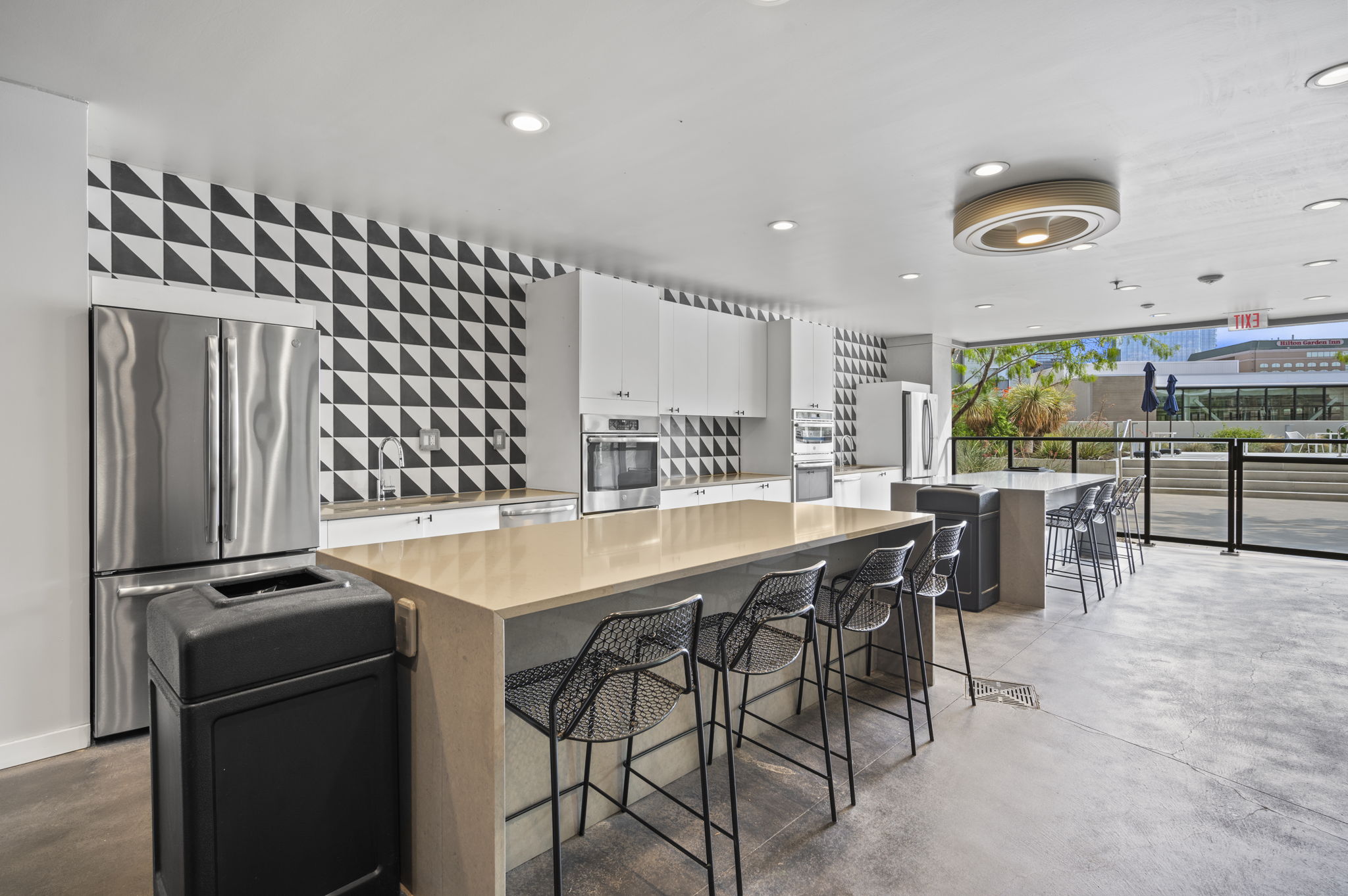 800 Embassy Drive, Unit 322 Austin, TX 78702 - Photo 28 of 31 a kitchen with stainless steel appliances granite countertop a stove a refrigerator a dining table and chairs
