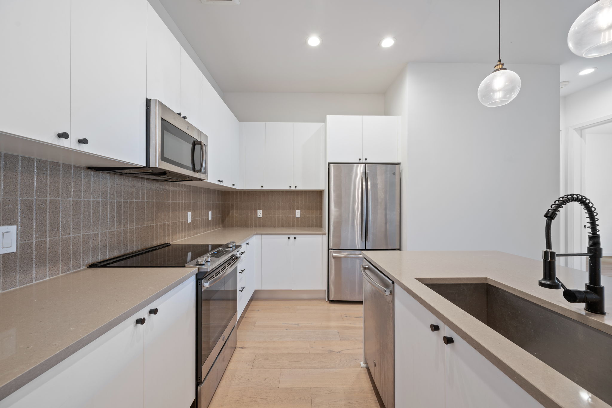 800 Embassy Drive, Unit 322 Austin, TX 78702 - Photo 4 of 31 a kitchen with stainless steel appliances granite countertop a sink and a stove