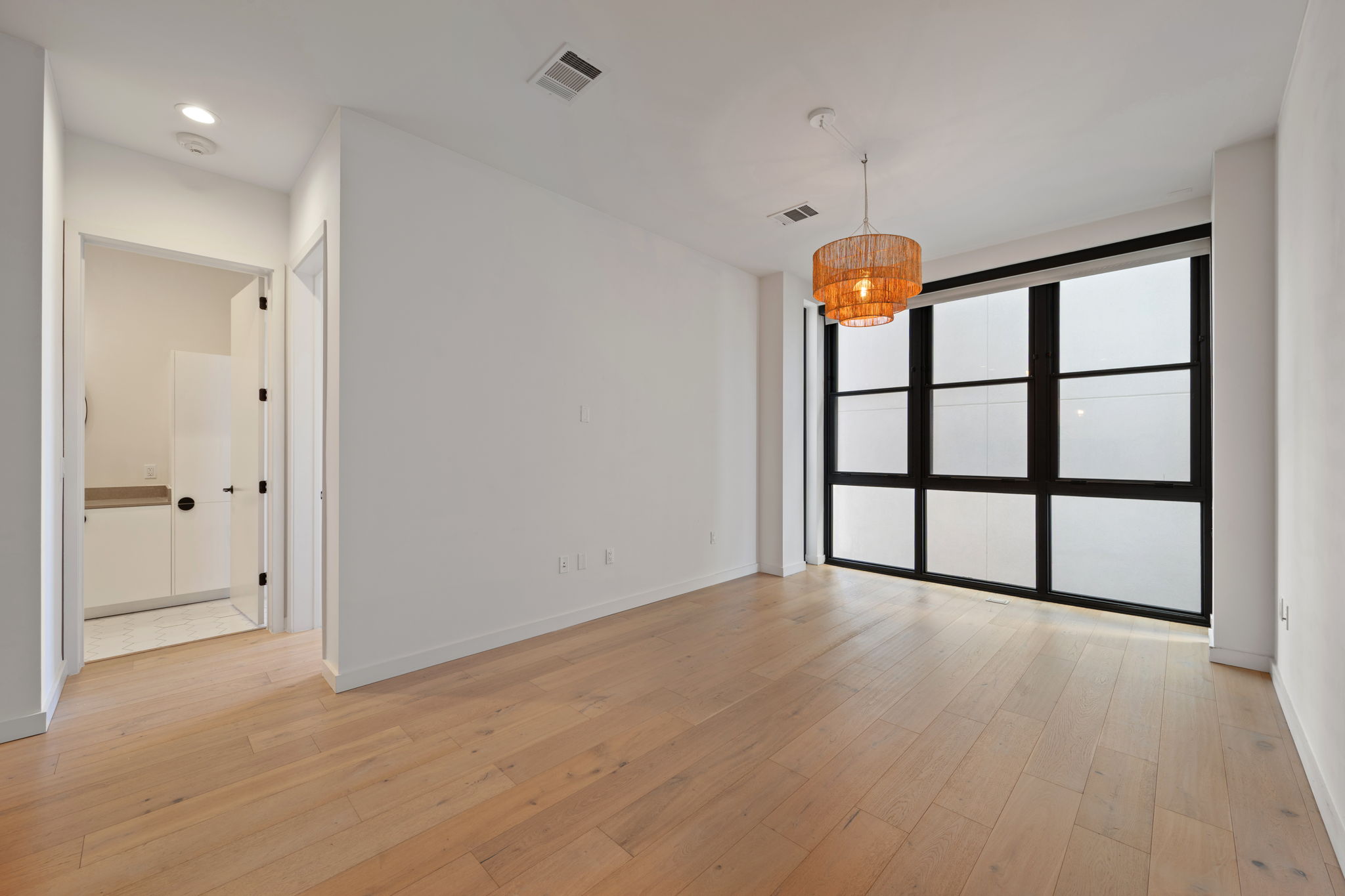 800 Embassy Drive, Unit 322 Austin, TX 78702 - Photo 7 of 31 wooden floor in an empty room with a window
