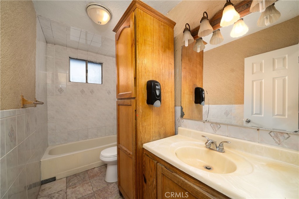 728 Geneva Street Anaheim, CA 92801 - Photo 12 of 24 a bathroom with a sink toilet tub and shower