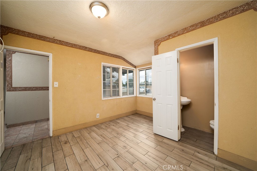 728 Geneva Street Anaheim, CA 92801 - Photo 16 of 24 a view of an empty room with wooden floor and a window