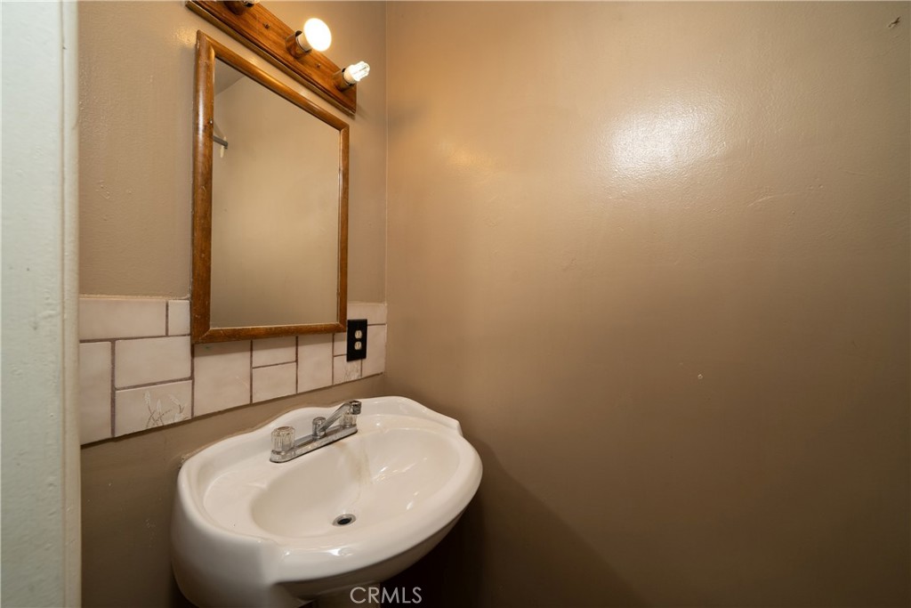 728 Geneva Street Anaheim, CA 92801 - Photo 17 of 24 a bathroom with a sink and a mirror