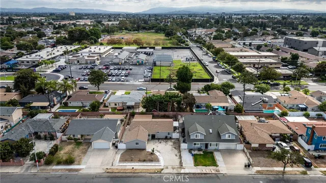an aerial view of a kitchen with a sink and large mirror