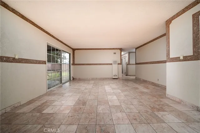 a view of a big room with a refrigerator