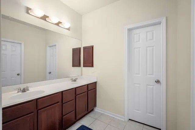 a bathroom with a double vanity sink and mirror