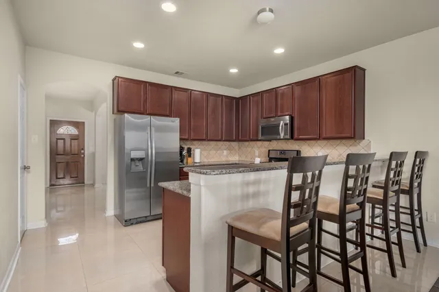 a kitchen with cabinets and stainless steel appliances